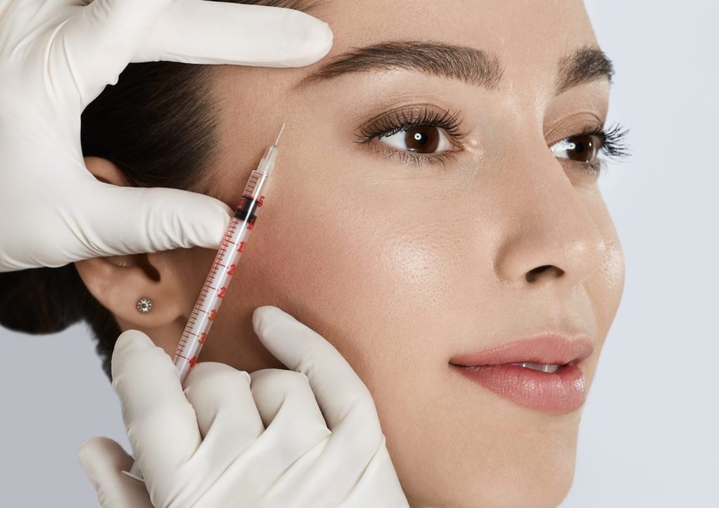 The best Guide to Dermal Fillers: all You Need to Know Before Your Appointment Photo: A woman getting dermal filler injected in the side of her eye area.