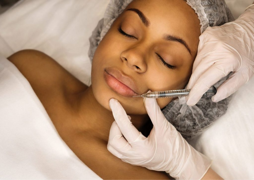 The best Guide to Dermal Fillers: all You Need to Know Before Your Appointment Photo- A woman getting dermal filler injected into her lips